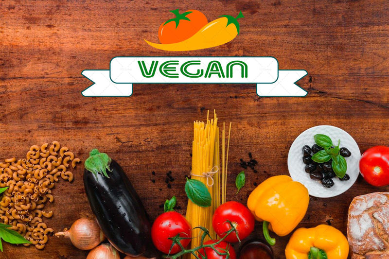 Veganské logo pro vegetariánskou společnost s oranžovými rajčaty a žlutým pepřem s nápisem v pásu na bílém pozadí